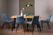 The Bentley Designs Ramsay Rustic Oak Effect Melamine 6 Seater Dining Table with 4 Legs & 6 Mondrian Petrol Blue Velvet Fabric Chairs with Sand Black Powder Coated Legs