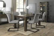 The Bentley Designs Turin Dark Oak 6-8 Seater Table & 6 Lewis Grey Velvet Fabric Cantilever Chairs with Sand Black Powder Coated Frame