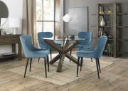 The Bentley Designs Turin Clear Tempered Glass 4 Seater Dining Table with Dark Oak Legs & 4 Cezanne Petrol Blue Velvet Fabric Chairs with Sand Black Powder Coated Legs