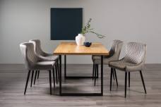 The Bentley Designs Ramsay Rustic Oak Effect Melamine 6 Seater Dining Table with U Leg & 4 Cezanne Grey Velvet Fabric Chairs with Sand Black Powder Coated Legs