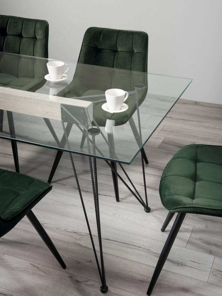 Close Up of The Bentley Designs Miro Clear Tempered Glass 6 Seater Dining Table & 6 Seurat Green Velvet Fabric Chairs with Sand Black Powder Coated Legs 