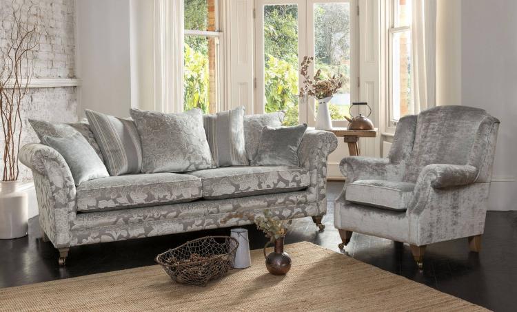 Grand sofa in fabric 9717, three pillows in 9717, two pillows in 9857, small scatter cushions in 9827, smokey oak pewter castor legs. Wing chair in fabric 9827, smokey oak pewter castor legs.