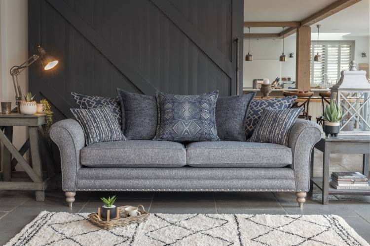 Grand sofa (pillow back) in fabric 2822, 2 pillows in 2132, 2 pillows in 2912, 1 pillow in 2362, small scatter cushions in 2272, grey ash/brushed nickel legs. Item shown with optional pewter studding.