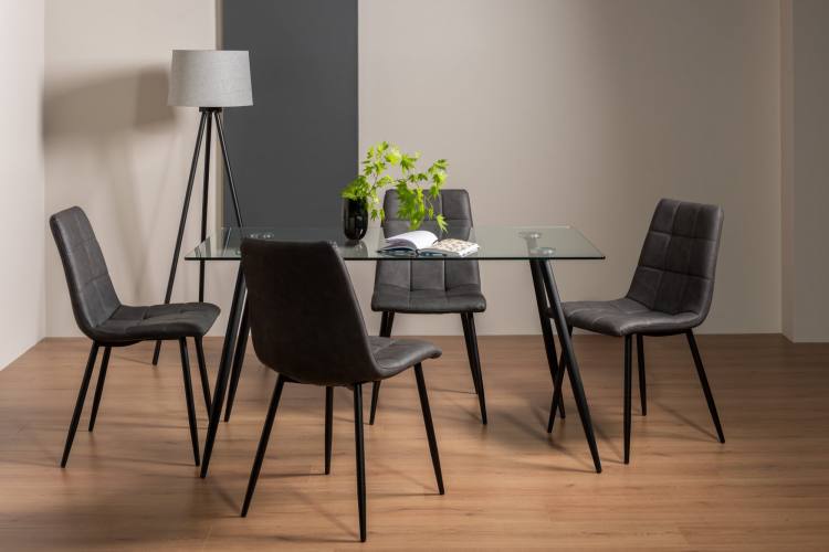 The Bentley Designs Martini Clear Tempered Glass 6 Seater Dining Table & 4 Mondrian Dark Grey Faux Leather Chairs with Sand Black Powder Coated Legs