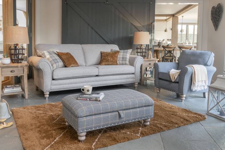 Grand sofa in fabric 1769, large scatter cushions in 2507, small scatter cushions in 2743, grey ash/brushed nickel legs. Accent chair in fabric 2557, grey ash/brushed nickel legs. Legged ottoman in fabric 2487, grey ash/brushed nickel legs. All items show